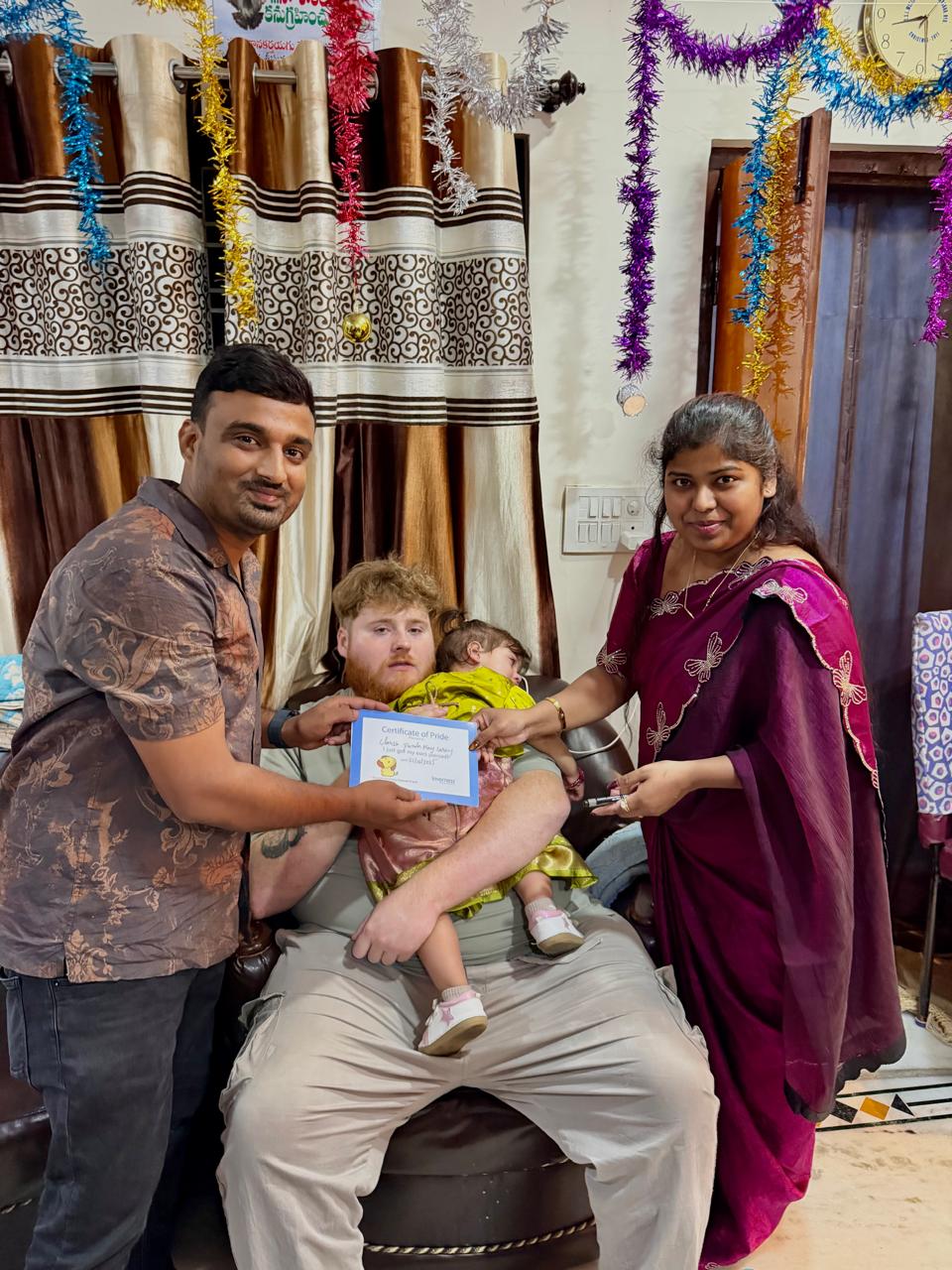 Parents and child celebrating ear piercing at home
