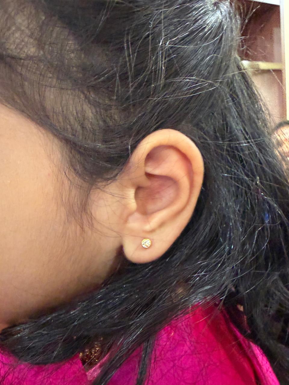 Happy family moment during professional home ear piercing